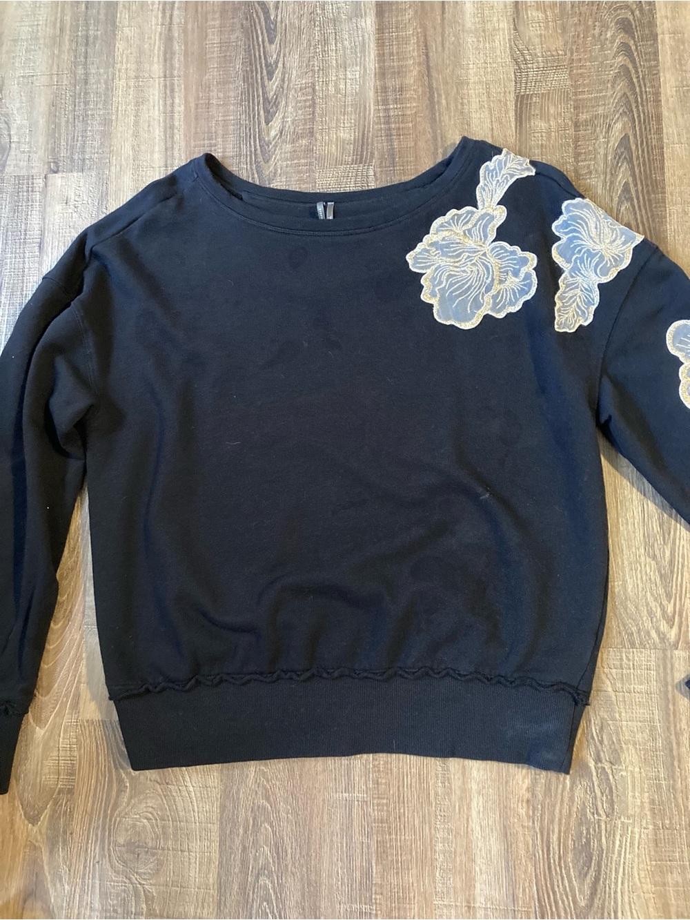Anthropologie Black Sweatshirt with Cream Floral Appliqué Shoulder Detail